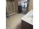 Bathroom featuring a shower, tub, tile flooring, and brown cabinets at 102 Kipling Dr, Oxford, NC 27565