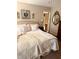 Bright bedroom with a queen bed, ornate decor, and an open doorway leading to another room at 102 Kipling Dr, Oxford, NC 27565