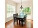 Sunlit dining area with wood floors, modern chandelier, table, and views of the outdoors at 102 Kipling Dr, Oxford, NC 27565