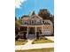 Inviting two-story home featuring a covered front porch, attached garage, and manicured lawn at 102 Kipling Dr, Oxford, NC 27565