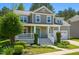 Inviting two-story home with a charming front porch, landscaped yard, and a gray-shingled exterior at 102 Kipling Dr, Oxford, NC 27565