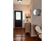 Welcoming foyer featuring hardwood floors, decorative mirror, and elegant furnishings at 102 Kipling Dr, Oxford, NC 27565