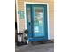 Inviting front door with a stylish blue paint, decorative lantern, and potted plants at 102 Kipling Dr, Oxford, NC 27565