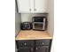Close-up of a countertop featuring a toaster and air fryer, with white cabinets above and dark cabinets below at 102 Kipling Dr, Oxford, NC 27565