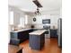 Modern kitchen with island, granite countertops, stainless steel appliances, and black/white cabinets at 102 Kipling Dr, Oxford, NC 27565