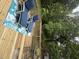Outdoor patio area with two chairs, an area rug, and a table surrounded by lush trees at 102 Kipling Dr, Oxford, NC 27565