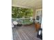 Covered porch with a cushioned bench and outdoor decor at 102 Kipling Dr, Oxford, NC 27565