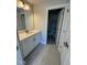 Bathroom features a single sink, gray tile floor and white door at 1033 Bostonian Dr, Knightdale, NC 27545