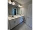 Well-lit bathroom features double sink vanity and tile flooring at 1033 Bostonian Dr, Knightdale, NC 27545