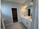 Bathroom with dual sink vanity and walk-in closet with wire shelving in the background at 1033 Bostonian Dr, Knightdale, NC 27545