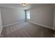 Spacious carpeted bedroom with a bright window and neutral color palette at 1033 Bostonian Dr, Knightdale, NC 27545
