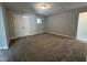 Carpeted bedroom with natural light from a small window and double doors at 1033 Bostonian Dr, Knightdale, NC 27545
