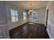 Spacious dining room featuring hardwood floors, large windows, and elegant wainscoting at 1033 Bostonian Dr, Knightdale, NC 27545