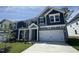 Charming home featuring gray siding, a two-car garage, and a well-manicured front lawn at 1033 Bostonian Dr, Knightdale, NC 27545