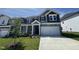 Charming home featuring gray siding, a two-car garage, and a well-manicured front lawn at 1033 Bostonian Dr, Knightdale, NC 27545