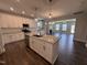 Bright kitchen featuring white cabinets, granite countertops, stainless steel appliances, and an island at 1033 Bostonian Dr, Knightdale, NC 27545