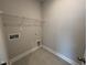 Compact laundry room with tile flooring and wire shelving; ready for washer and dryer hookups at 1033 Bostonian Dr, Knightdale, NC 27545