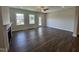 Open living room featuring dark wood floors, a fireplace, and bright natural light from windows at 1033 Bostonian Dr, Knightdale, NC 27545