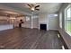 Open-concept living room with fireplace and dark wood floors adjacent to the kitchen at 1033 Bostonian Dr, Knightdale, NC 27545