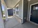Inviting covered porch featuring brick accents, gray siding, and white columns at 1033 Bostonian Dr, Knightdale, NC 27545