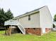 Rear view featuring a raised deck, stairs, showcasing outdoor living space and access at 106 Grange Dr, Wendell, NC 27591
