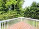 An inviting backyard deck surrounded by lush greenery offers a private outdoor space at 106 Grange Dr, Wendell, NC 27591