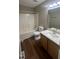 Cozy bathroom with a shower-tub combo, wooden cabinets, tile floor, and a large sink at 106 Grange Dr, Wendell, NC 27591