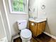 Powder room with a toilet, a vanity, quartz countertops, and wood-look vinyl flooring at 106 Grange Dr, Wendell, NC 27591