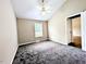 Bedroom with carpeted floors, neutral walls, a window, and a ceiling fan with light fixture at 106 Grange Dr, Wendell, NC 27591