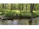 Tranquil creek flowing through wooded property, enhancing its natural charm at 106 Grange Dr, Wendell, NC 27591