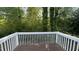 Enjoy serene outdoor views from this wood deck overlooking lush, mature trees and greenery at 106 Grange Dr, Wendell, NC 27591