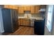This well-lit kitchen is equipped with stainless steel appliances, lots of cabinet space, and wood-look floors at 106 Grange Dr, Wendell, NC 27591