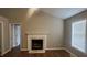 Charming living room with vaulted ceilings, wood flooring, and a traditional fireplace with white mantel at 106 Grange Dr, Wendell, NC 27591