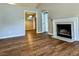 Open-concept living room featuring hardwood floors, classic fireplace and views to adjacent rooms at 106 Grange Dr, Wendell, NC 27591