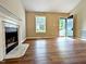 Spacious living room featuring new hardwood floors and a classic fireplace at 106 Grange Dr, Wendell, NC 27591