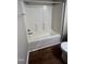 This bathroom features a shower-tub combo, white finish, and laminate flooring at 106 Grange Dr, Wendell, NC 27591