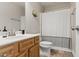 Bathroom features a vanity with ample storage, toilet, and shower with a modern shower curtain at 108 Hudson Dr, Princeton, NC 27569