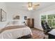 Bedroom with ceiling fan, wood-look floors, and a window offering outdoor views at 108 Hudson Dr, Princeton, NC 27569