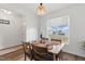 Open dining area with modern table setting, decor, and a large window providing ample natural light at 108 Hudson Dr, Princeton, NC 27569