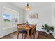 Dining area with natural light from a large window, showcasing the wood floors and modern furnishings at 108 Hudson Dr, Princeton, NC 27569