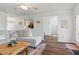 Open-concept living area with hardwood floors, comfortable seating, and ample natural light from the doorway at 108 Hudson Dr, Princeton, NC 27569