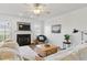 Bright living room with a cozy fireplace, ceiling fan, and stylish furnishings, creating an inviting atmosphere at 108 Hudson Dr, Princeton, NC 27569