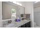 Bright bathroom with dual sinks, a granite countertop, a large mirror, and a glass-door shower at 111 Killam Ct # 2A, Cary, NC 27513