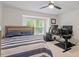 Cozy bedroom featuring a ceiling fan, a bed, and a black table with dual monitors at 111 Killam Ct # 2A, Cary, NC 27513
