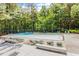 Spacious community pool area surrounded by lush trees and lounge chairs at 111 Killam Ct # 2A, Cary, NC 27513