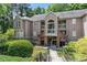 Inviting condo exterior with landscaped entrance and private balconies, nestled among mature trees at 111 Killam Ct # 2A, Cary, NC 27513