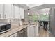 Modern kitchen with stainless steel appliances, marble countertops, and eat-in breakfast bar at 111 Killam Ct # 2A, Cary, NC 27513
