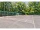 Fenced tennis court surrounded by trees and lush landscaping in this active community at 111 Killam Ct # 2A, Cary, NC 27513