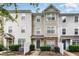Charming multi-story townhouse with stone accents and well-maintained landscaping at 1220 Canyon Rock Ct # 107, Raleigh, NC 27610