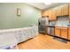Kitchen with stainless steel appliances, light wood cabinets, and hardwood floors at 1220 Canyon Rock Ct # 107, Raleigh, NC 27610